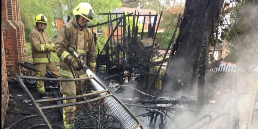 Fireman putting out a fire on church roof